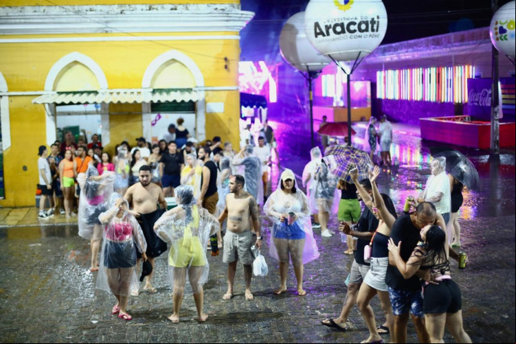 SEJA com capas, protegendo-se sob marquise ou se molhando mesmo, chuva não impediu folia em Aracati SEJA com capas, protegendo-se sob marquise ou se molhando mesmo, chuva não impediu folia em Aracati